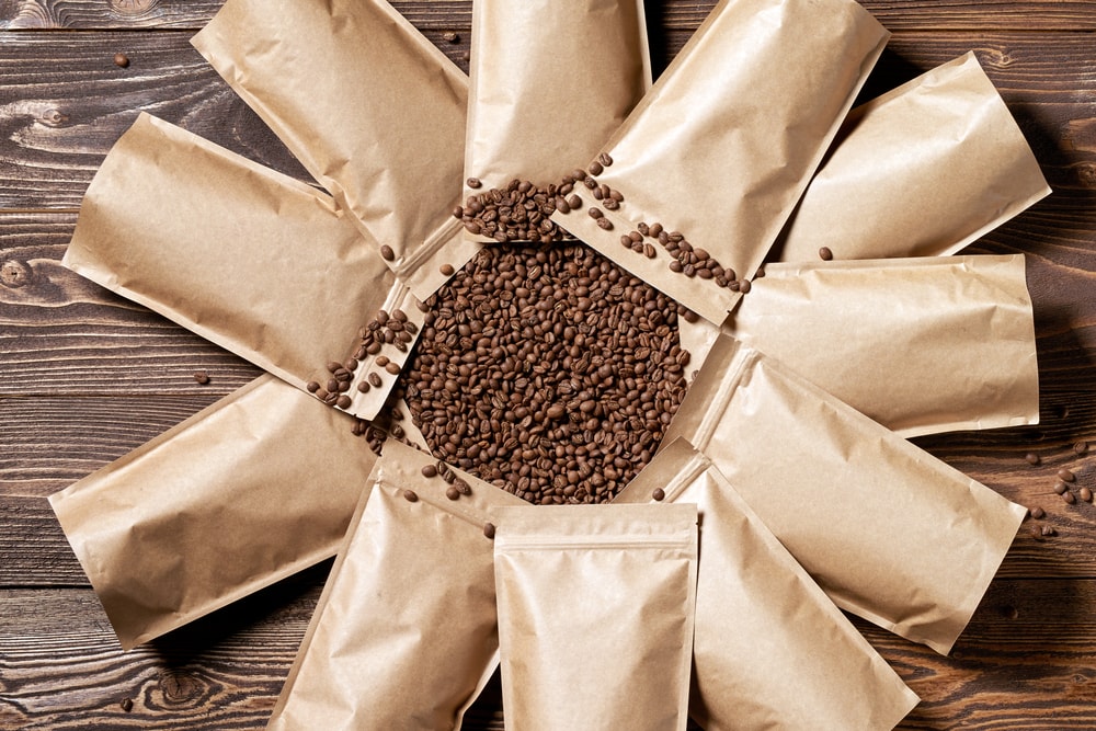 Circle of coffee bags with coffee beans in the centre